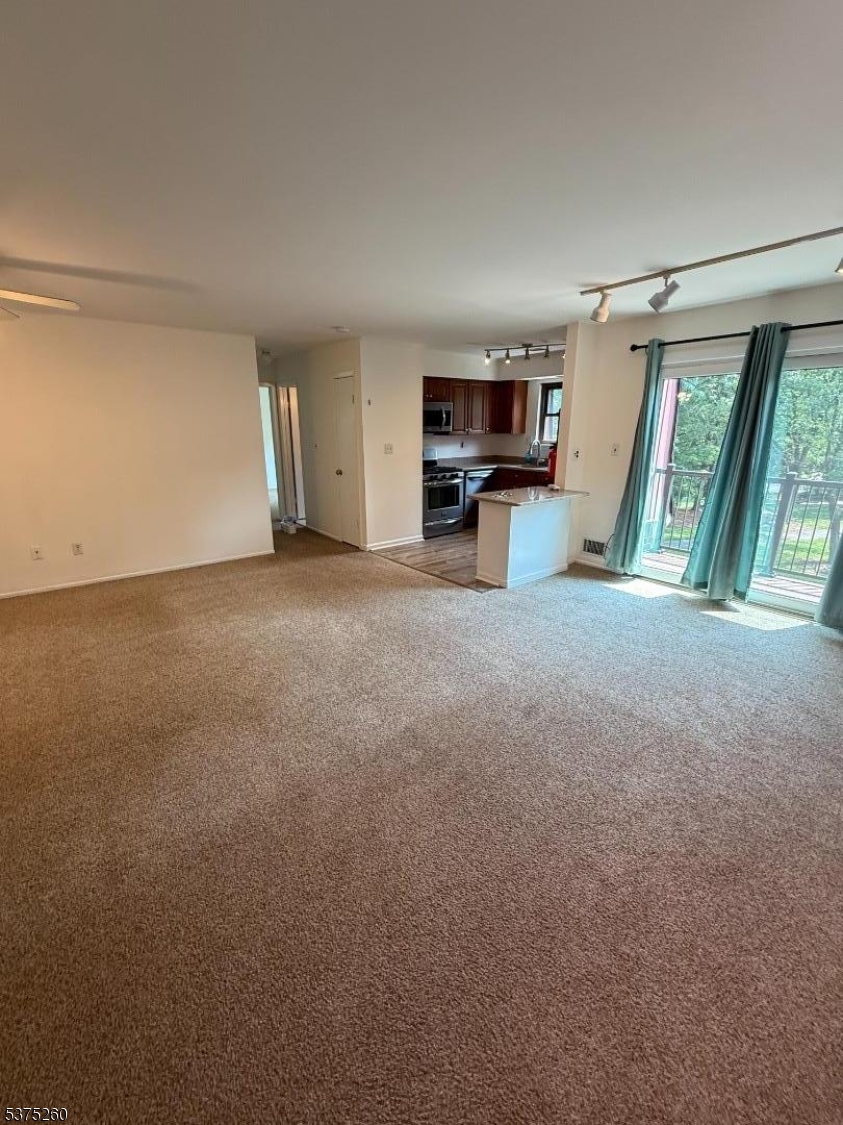 606 Nottingham Way Flemington, NJ 08822 - Photo 7 of 17 a view of a big room with furniture and a kitchen