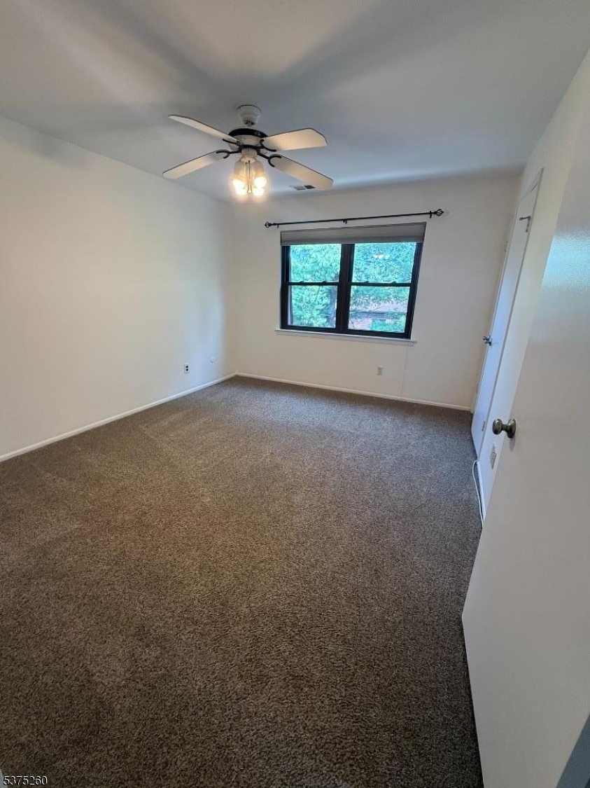 606 Nottingham Way Flemington, NJ 08822 - Photo 10 of 17 an empty room with windows and ceiling fan view
