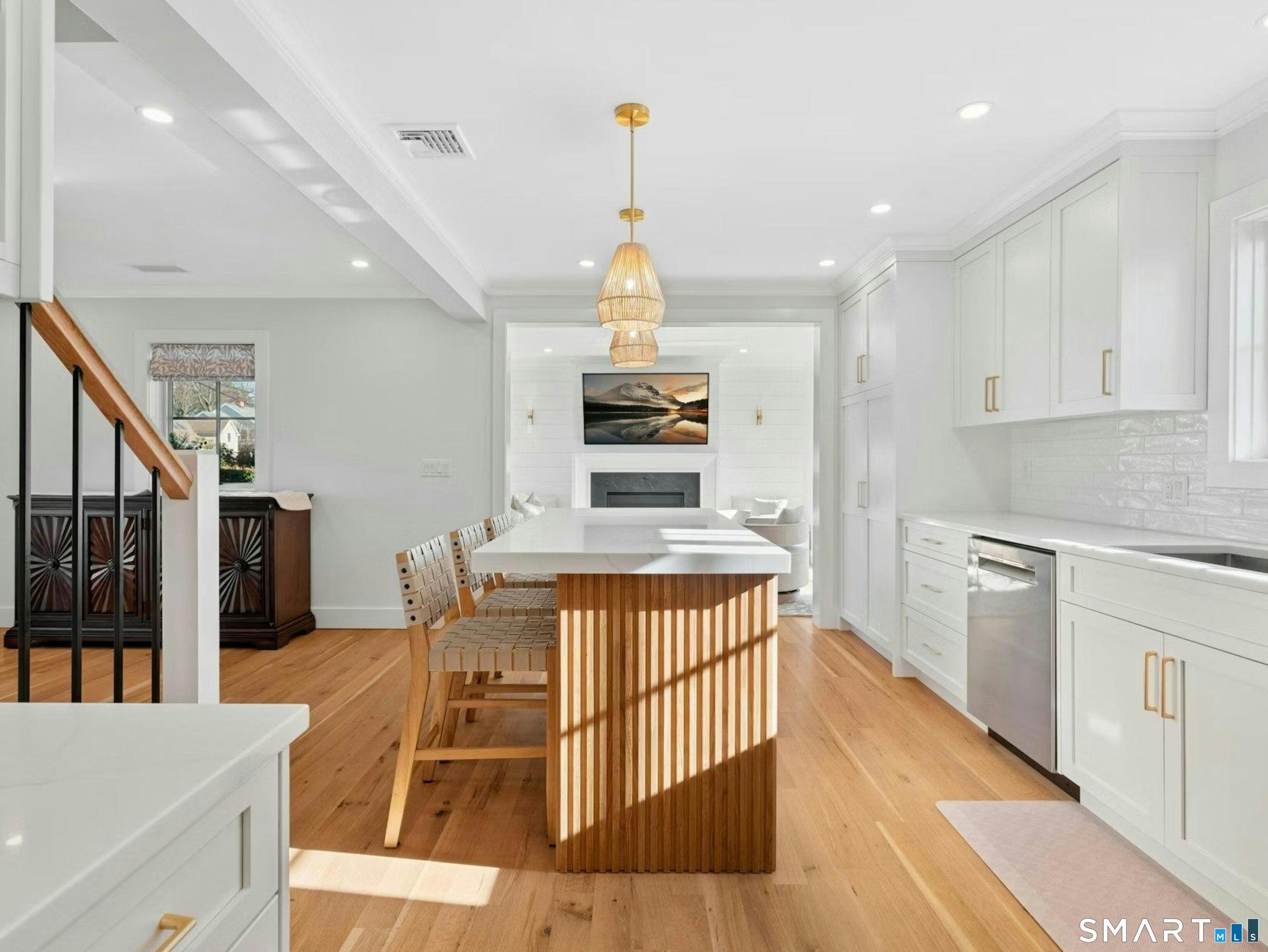 13 Patton Drive Darien, CT 06820 - Photo 11 of 26 a kitchen with stainless steel appliances granite countertop a stove top oven a sink dishwasher and a dining table with wooden floor