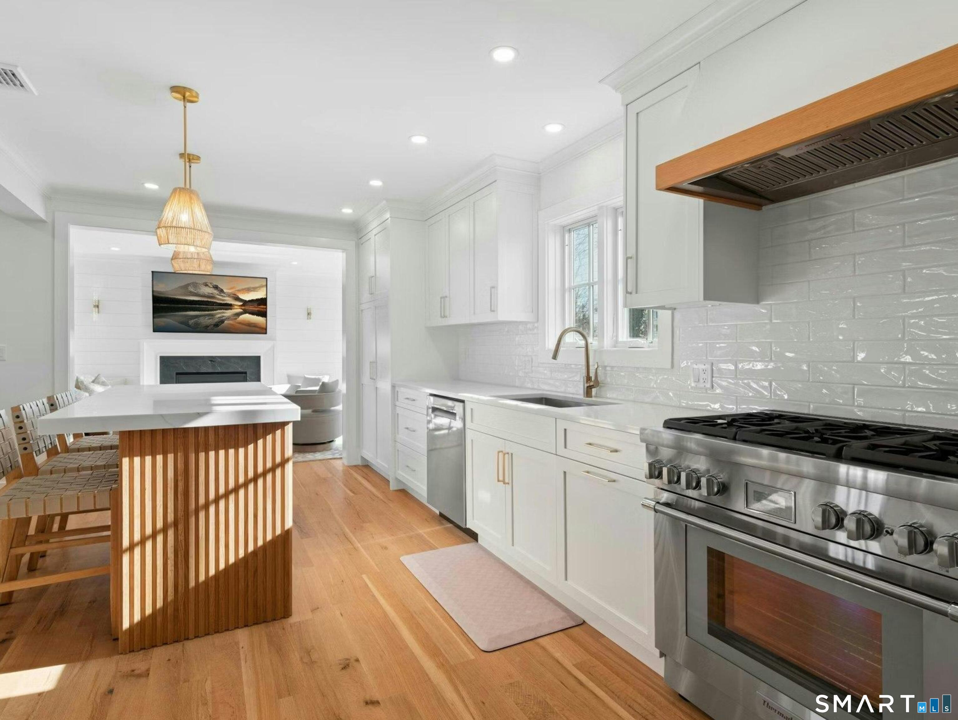 13 Patton Drive Darien, CT 06820 - Photo 12 of 26 a kitchen with stainless steel appliances granite countertop a stove a sink and a refrigerator