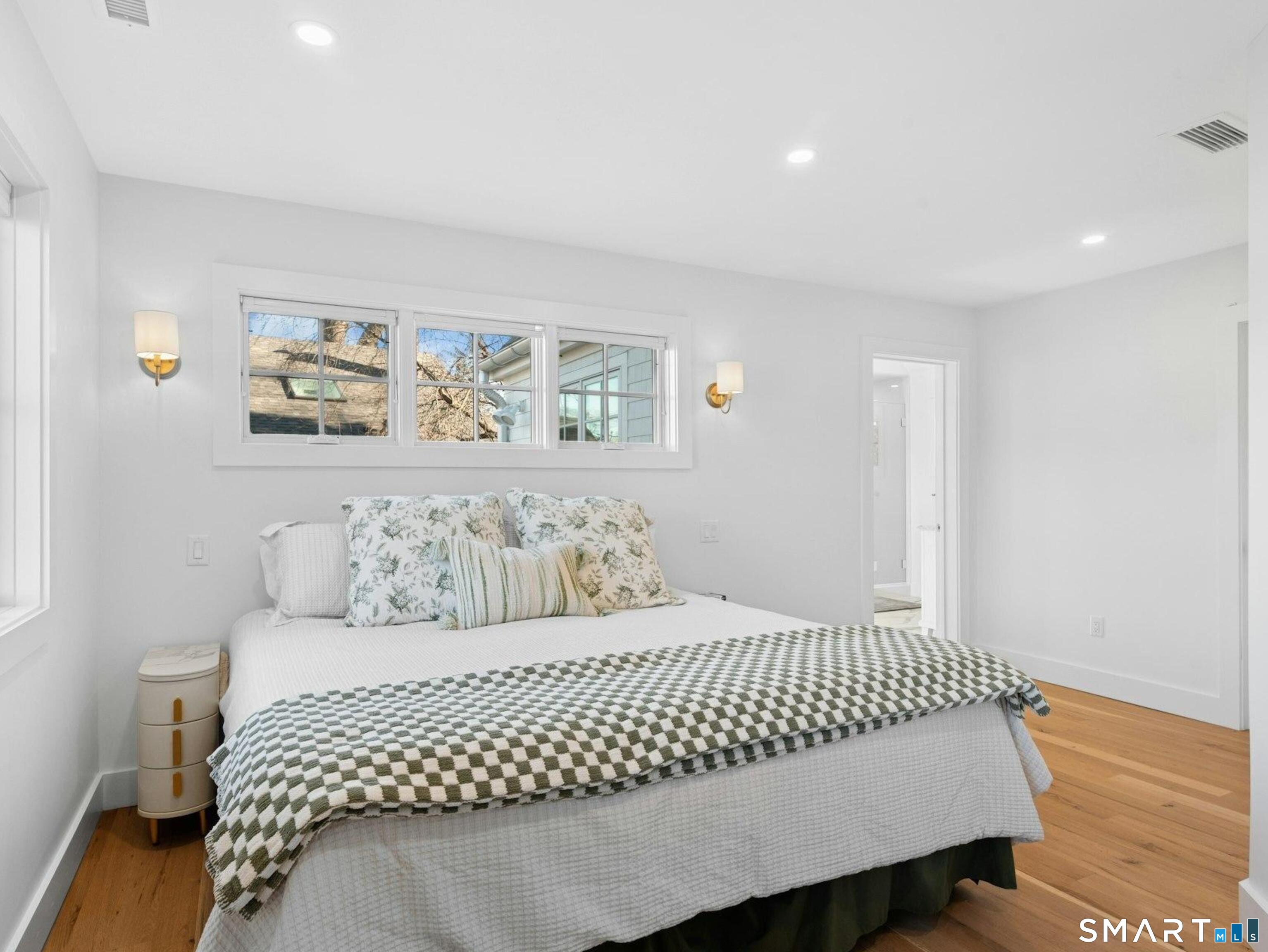 13 Patton Drive Darien, CT 06820 - Photo 16 of 26 a bedroom with a bed and painting on the wall