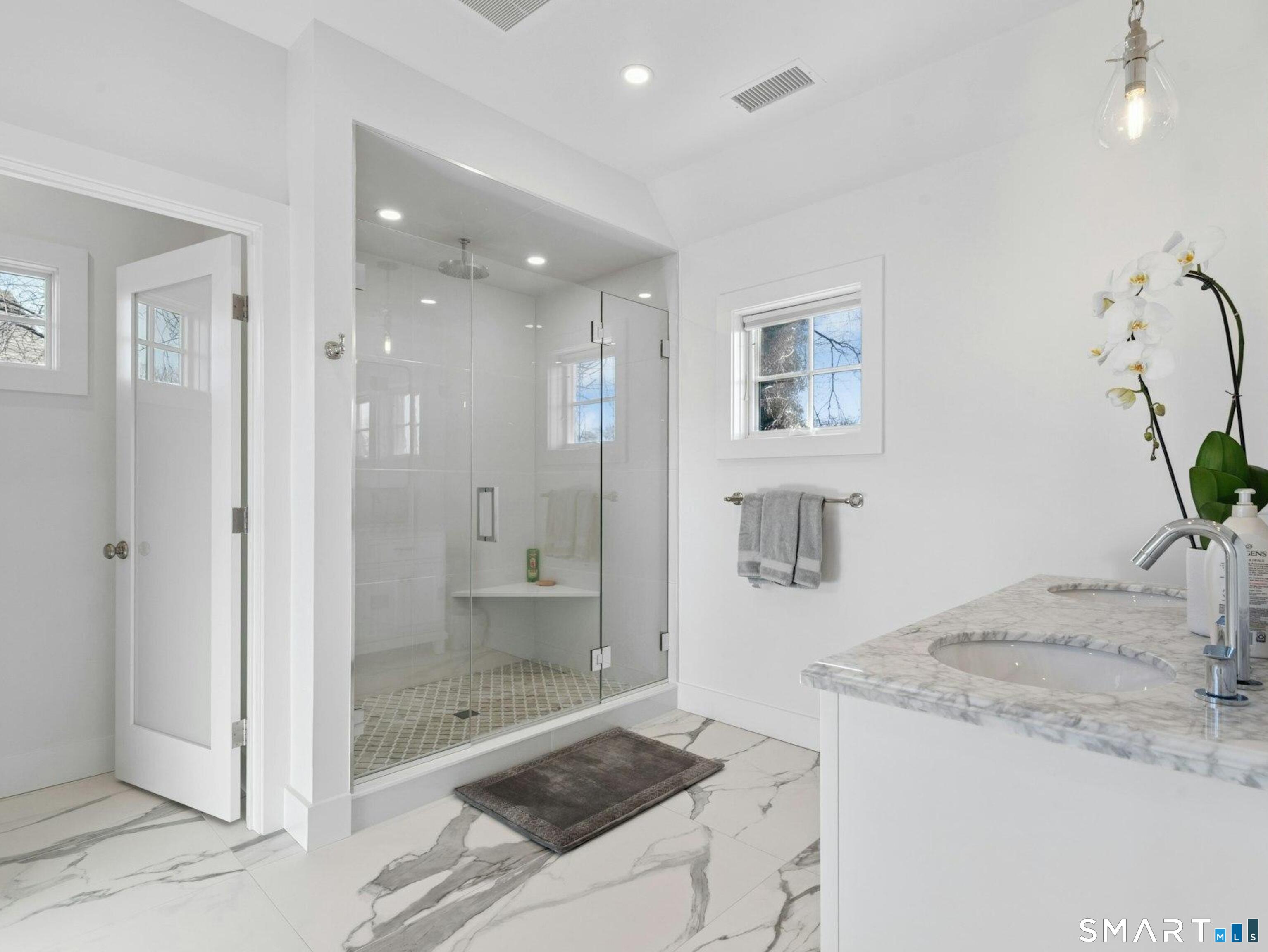 13 Patton Drive Darien, CT 06820 - Photo 17 of 26 a bathroom with a granite countertop sink a mirror and a shower
