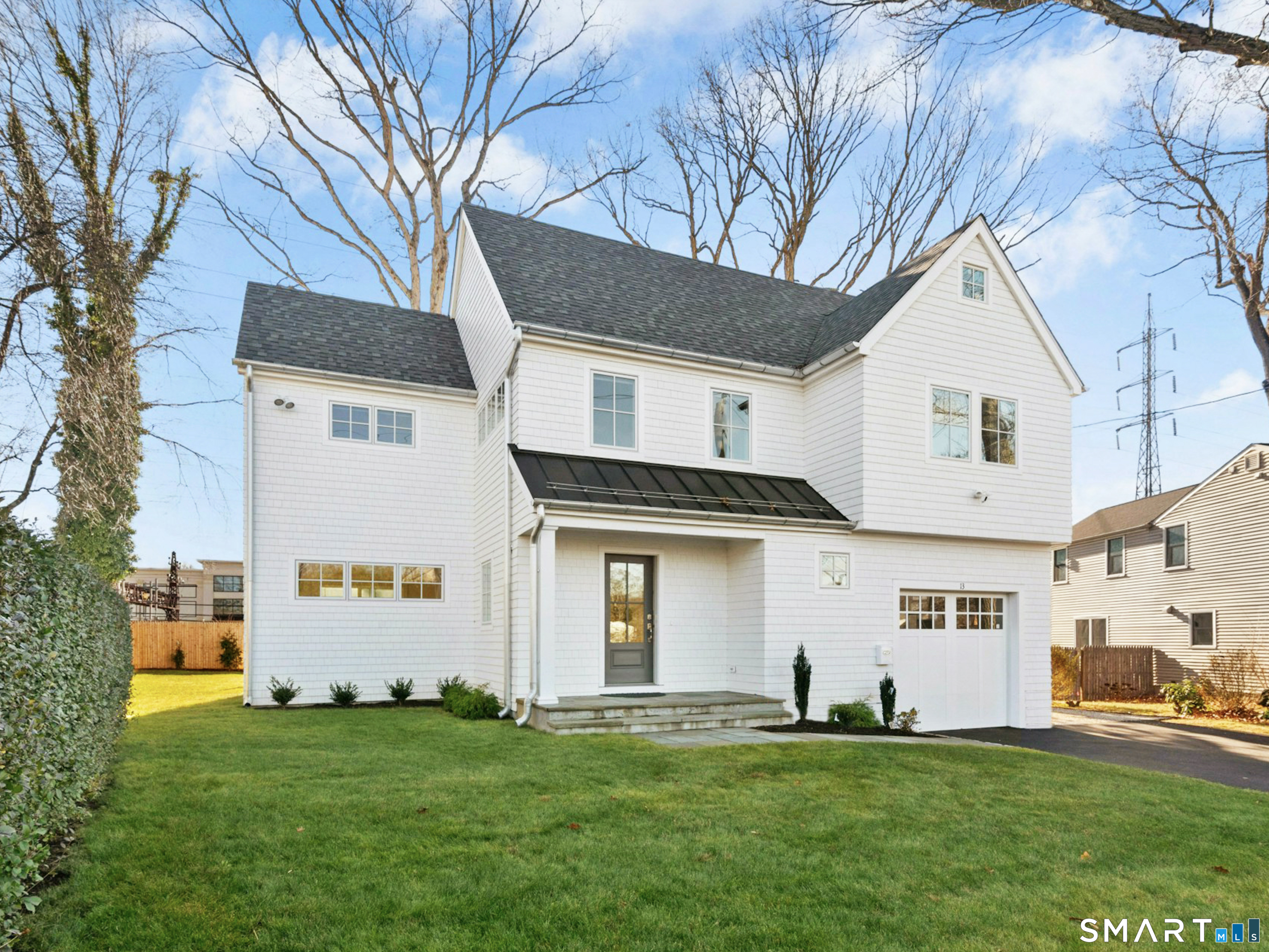 13 Patton Drive Darien, CT 06820 - Photo 2 of 26 a front view of a house with a garden