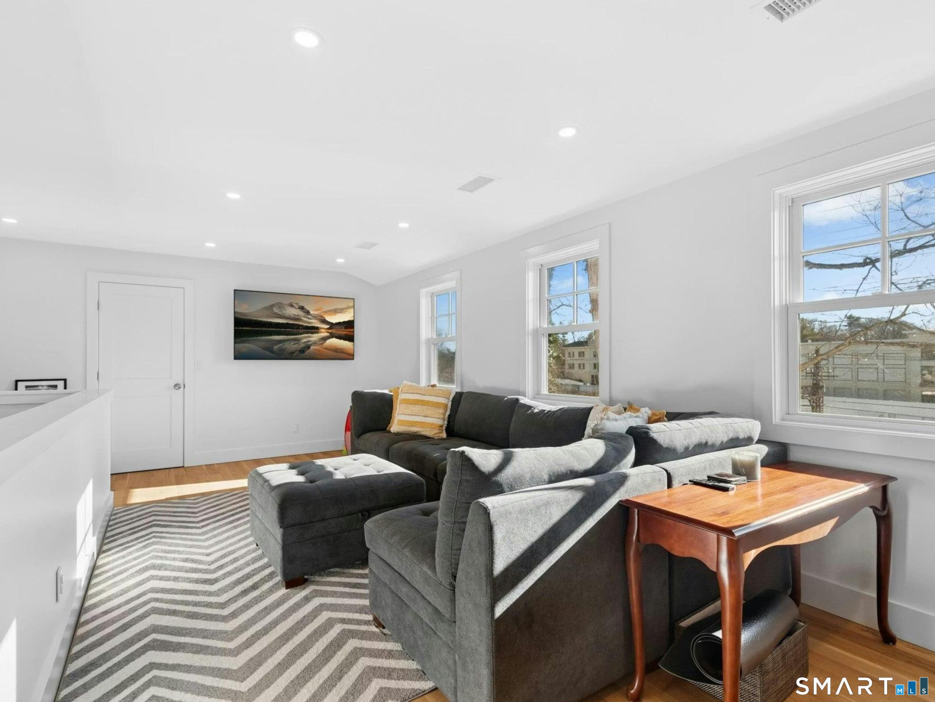 13 Patton Drive Darien, CT 06820 - Photo 22 of 26 a living room with furniture and a flat screen tv