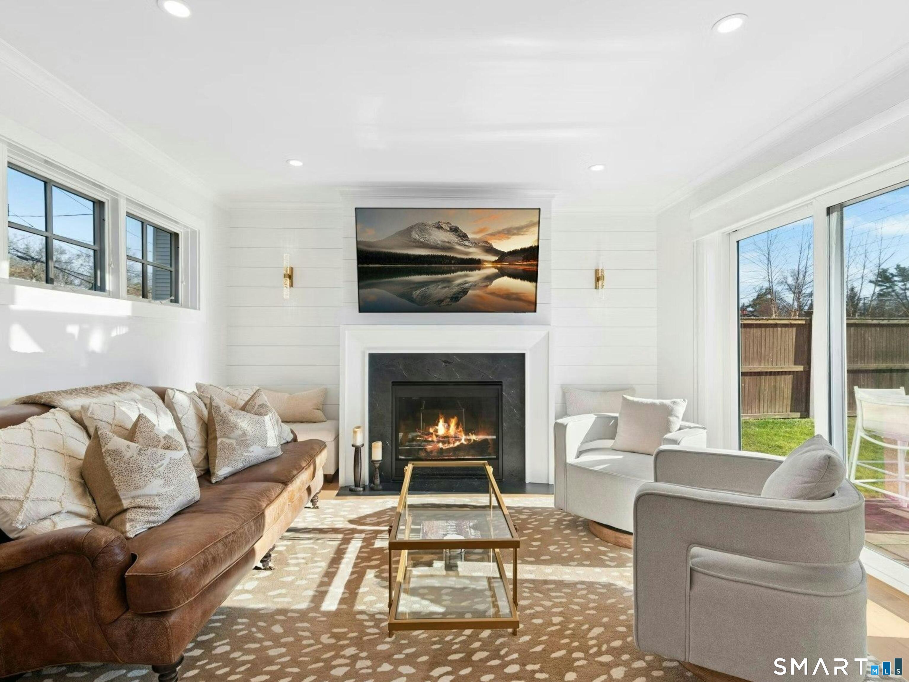 13 Patton Drive Darien, CT 06820 - Photo 4 of 26 a living room with furniture a rug and a fireplace