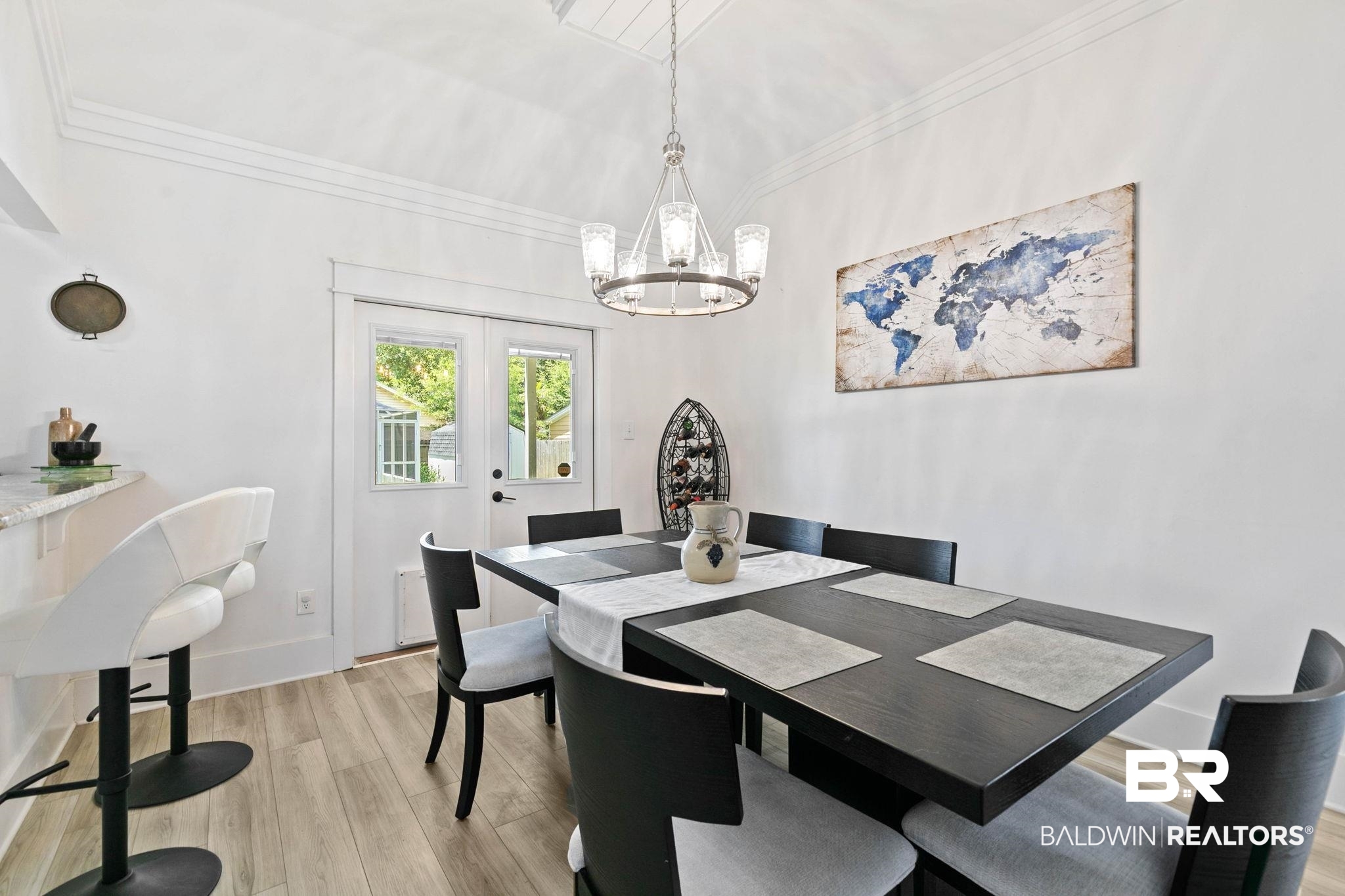 520 Juniper Place Drive Foley, AL 36535 - Photo 8 of 35 Bright dining area featuring wood-finish flooring, a contemporary chandelier, crown molding, and double French doors to the deck.