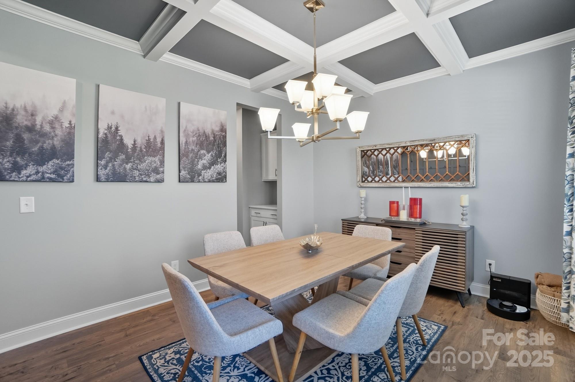 1325 Black Walnut Street Monroe, NC 28112 - Photo 13 of 46 a view of a dining room with furniture a chandelier and wooden floor