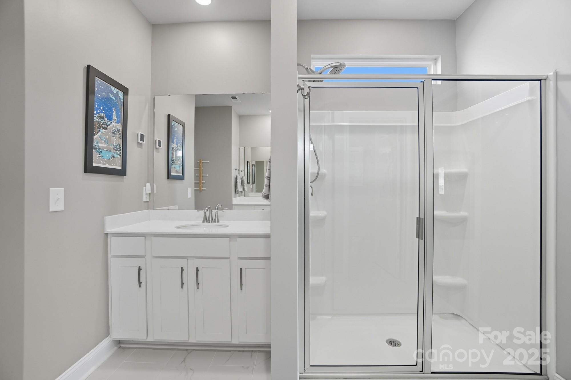 1325 Black Walnut Street Monroe, NC 28112 - Photo 21 of 46 a bathroom with a granite countertop sink mirror and shower