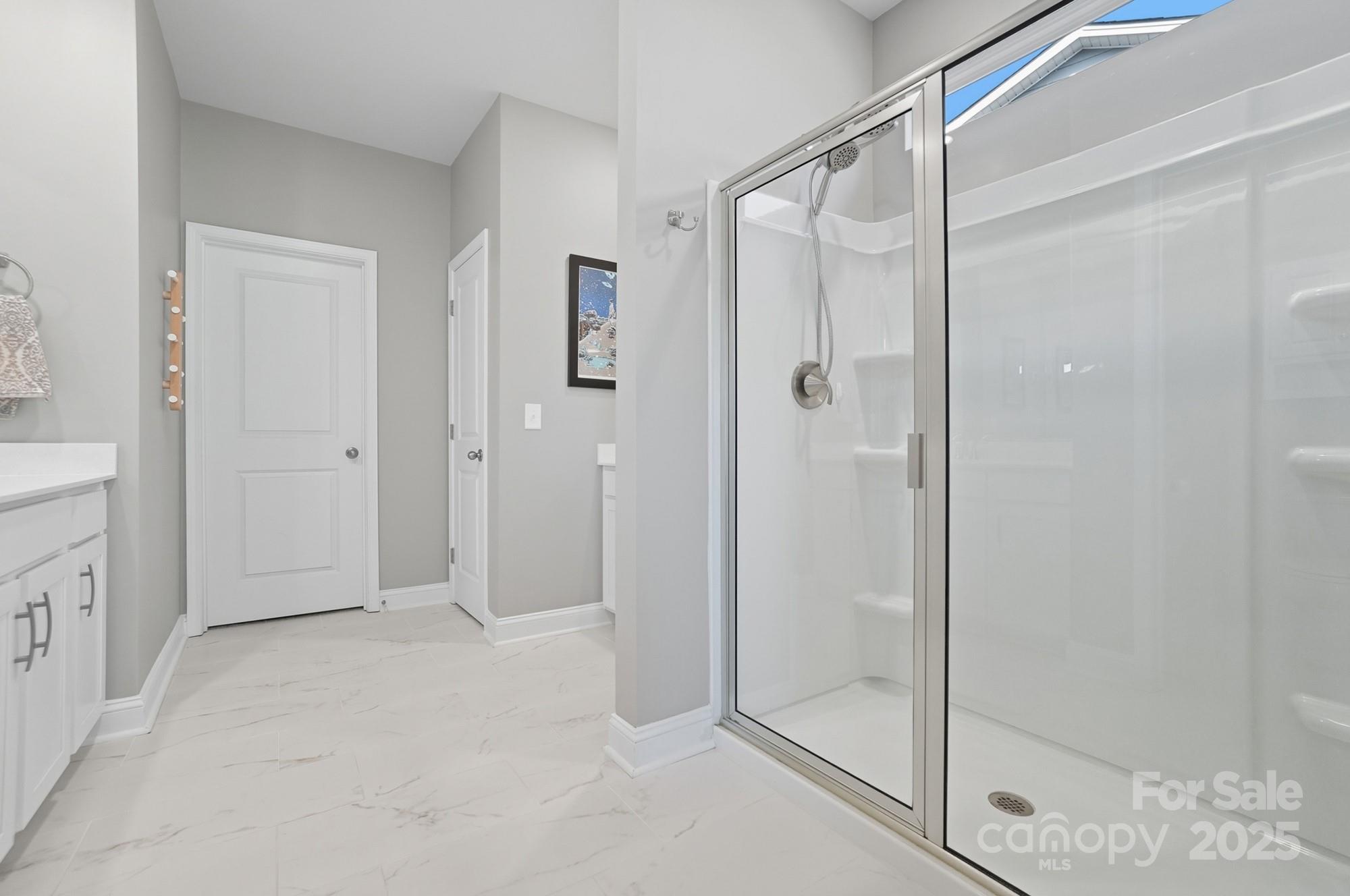 1325 Black Walnut Street Monroe, NC 28112 - Photo 22 of 46 a bathroom with a glass shower door
