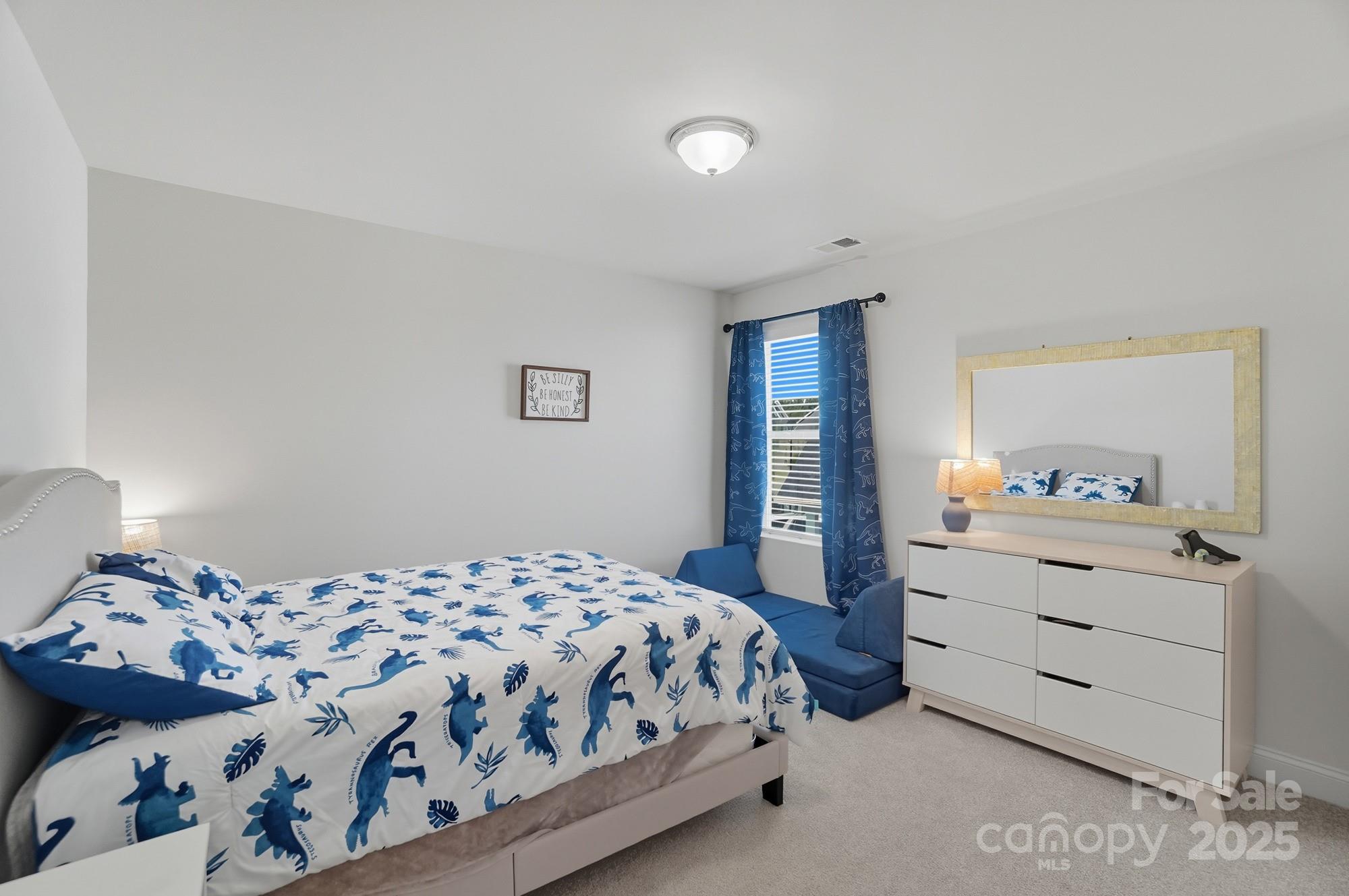 1325 Black Walnut Street Monroe, NC 28112 - Photo 30 of 46 a bedroom with a bed and a dresser