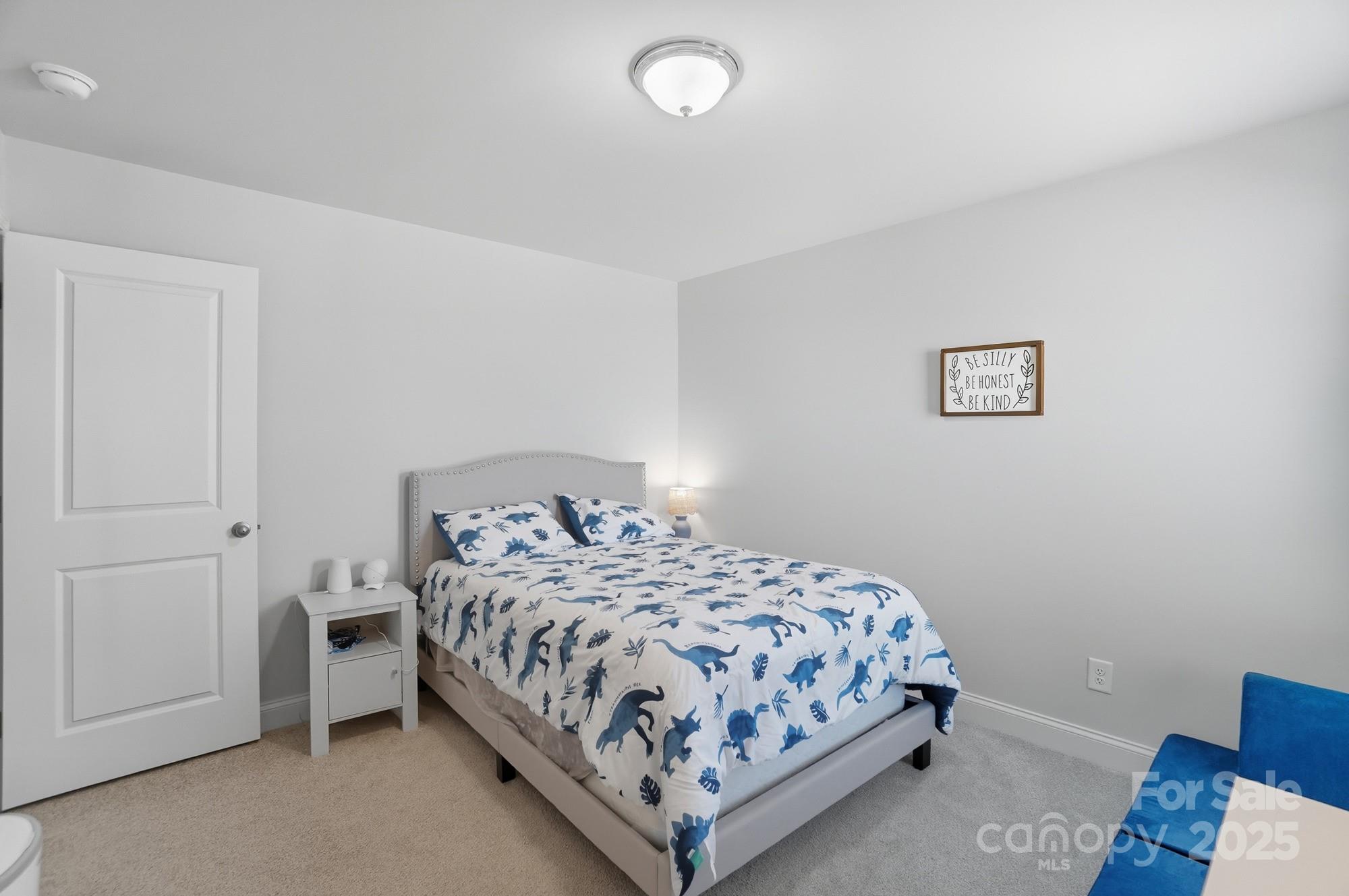 1325 Black Walnut Street Monroe, NC 28112 - Photo 31 of 46 a bedroom with a bed and painting on the wall
