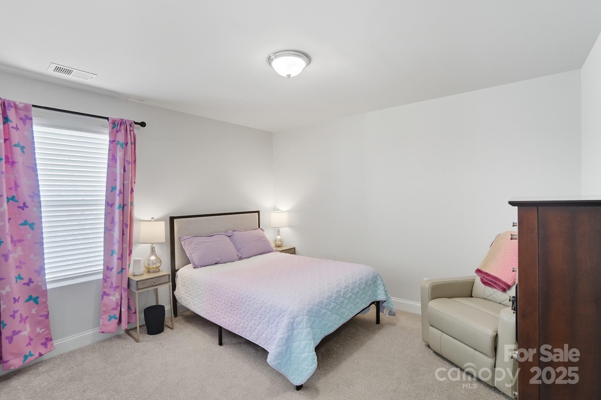 1325 Black Walnut Street Monroe, NC 28112 - Photo 33 of 46 a bedroom with a bed and a couch