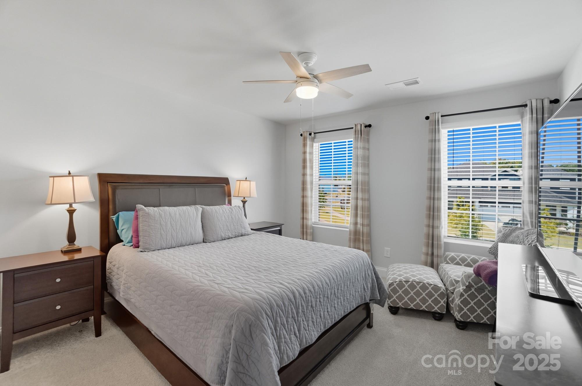 1325 Black Walnut Street Monroe, NC 28112 - Photo 38 of 46 a bedroom with a bed and a chandelier