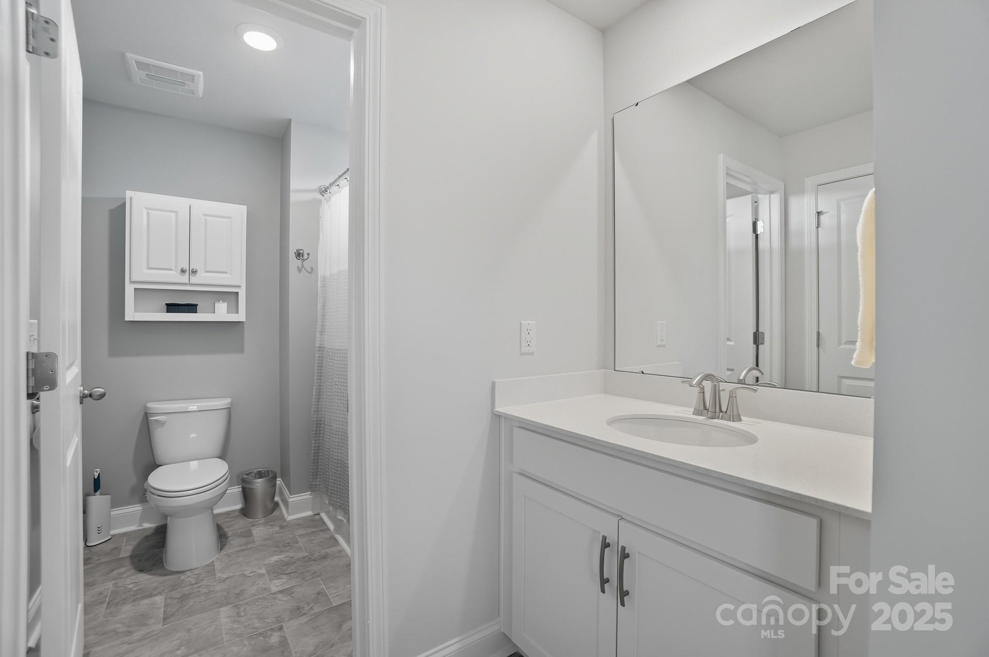 1325 Black Walnut Street Monroe, NC 28112 - Photo 41 of 46 a bathroom with a toilet sink and mirror