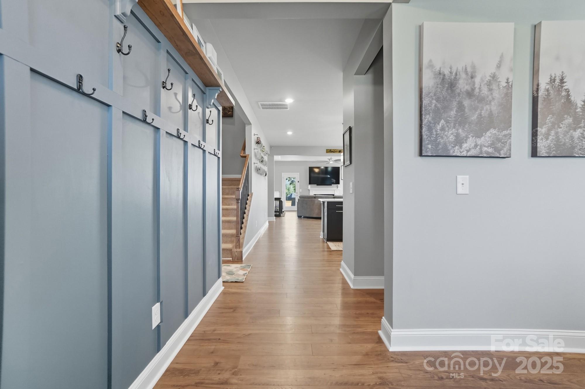 1325 Black Walnut Street Monroe, NC 28112 - Photo 7 of 46 a view of a hallway with wooden floor and staircase