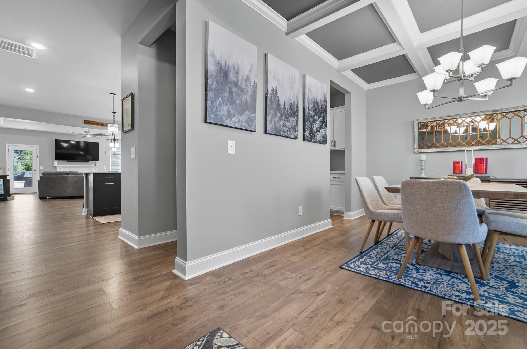 1325 Black Walnut Street Monroe, NC 28112 - Photo 10 of 46 a view of a dining room with furniture a chandelier and wooden floor