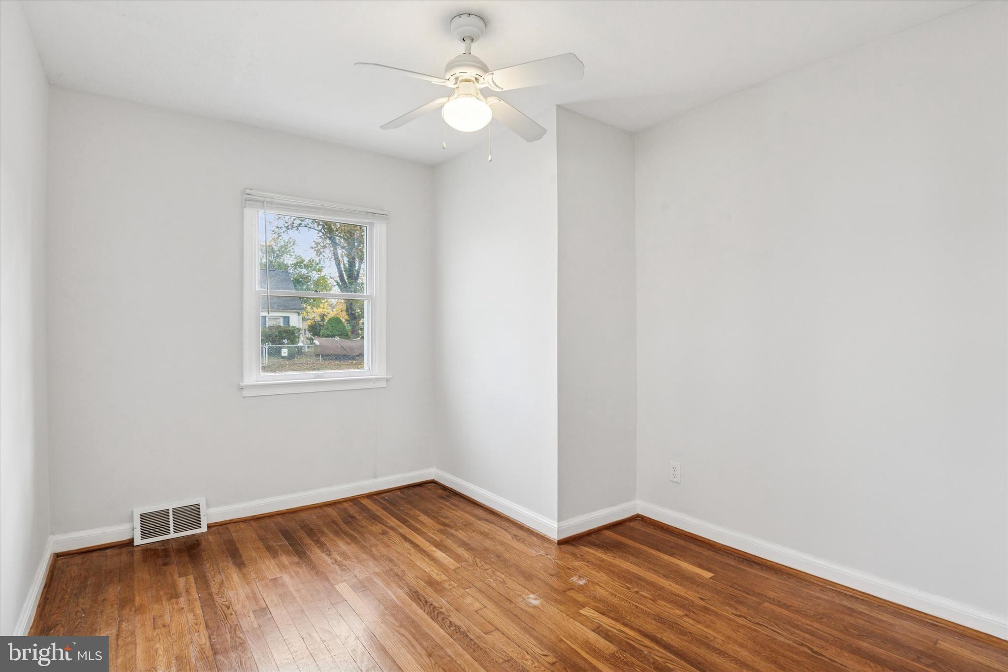 206 Decalb Avenue Wilmington, DE 19804 - Photo 6 of 14 wooden floor in an empty room with a window