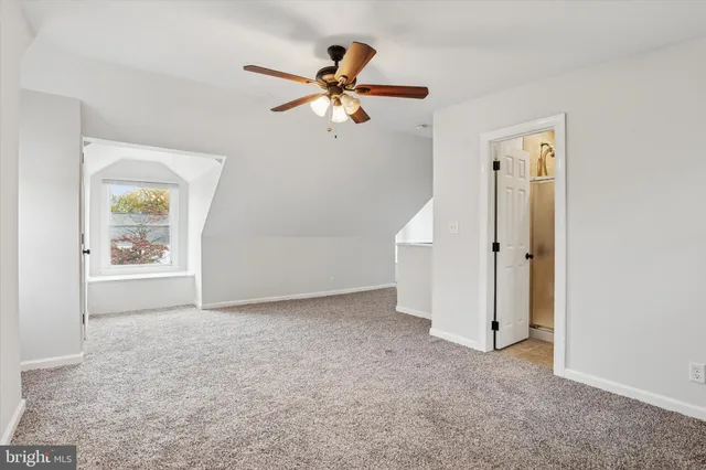 an empty room with closet and a window