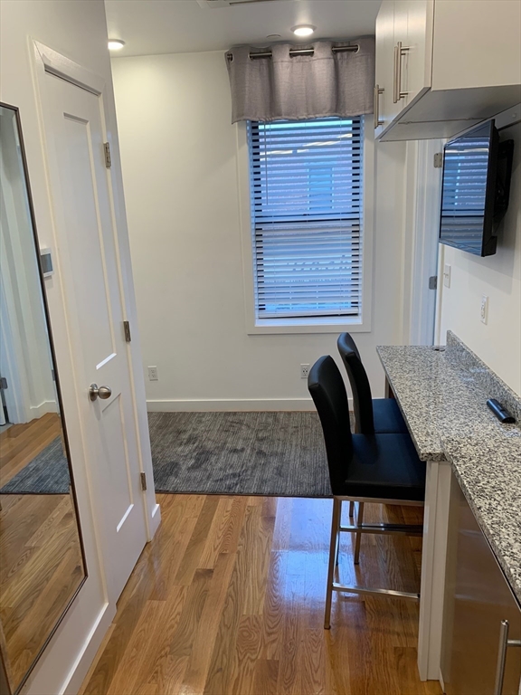 16 5th Street, Unit 6 Chelsea, MA 02150 - Photo 5 of 7 a living room with furniture and a wooden floor