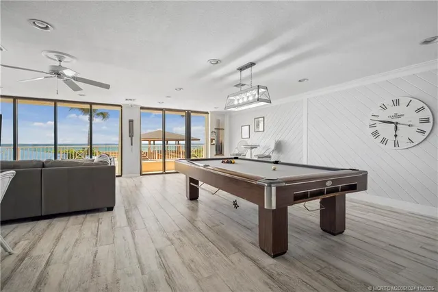 a living room with a table and large windows