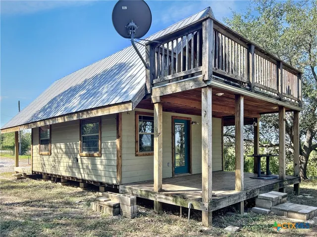 a backyard of a house with barbeque oven table and chairs