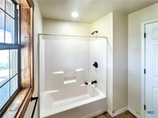a bathroom with a bathtub and a shower