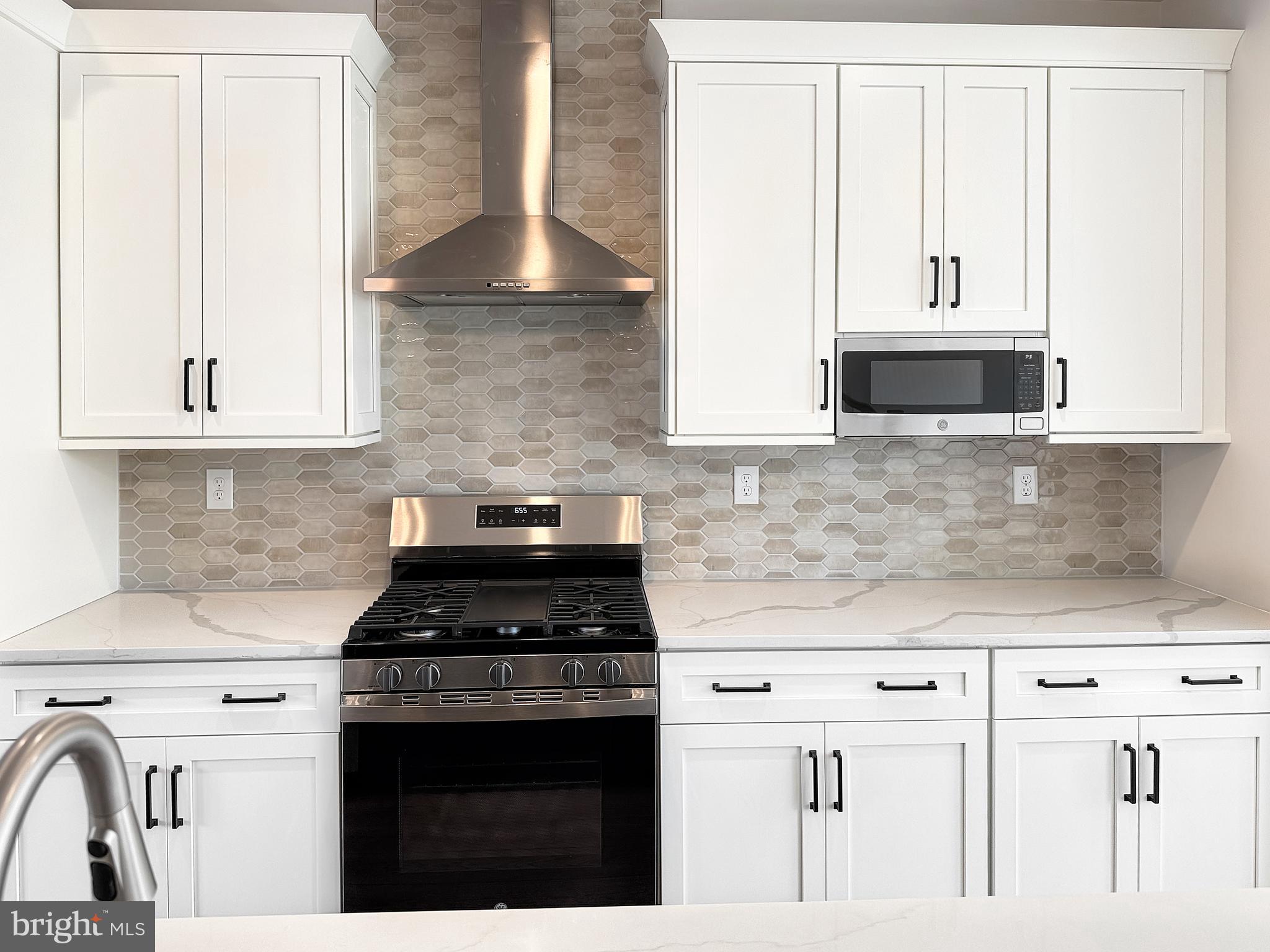 14 Schadle Road Perkasie, PA 18944 - Photo 11 of 44 a kitchen with granite countertop white cabinets and black appliances