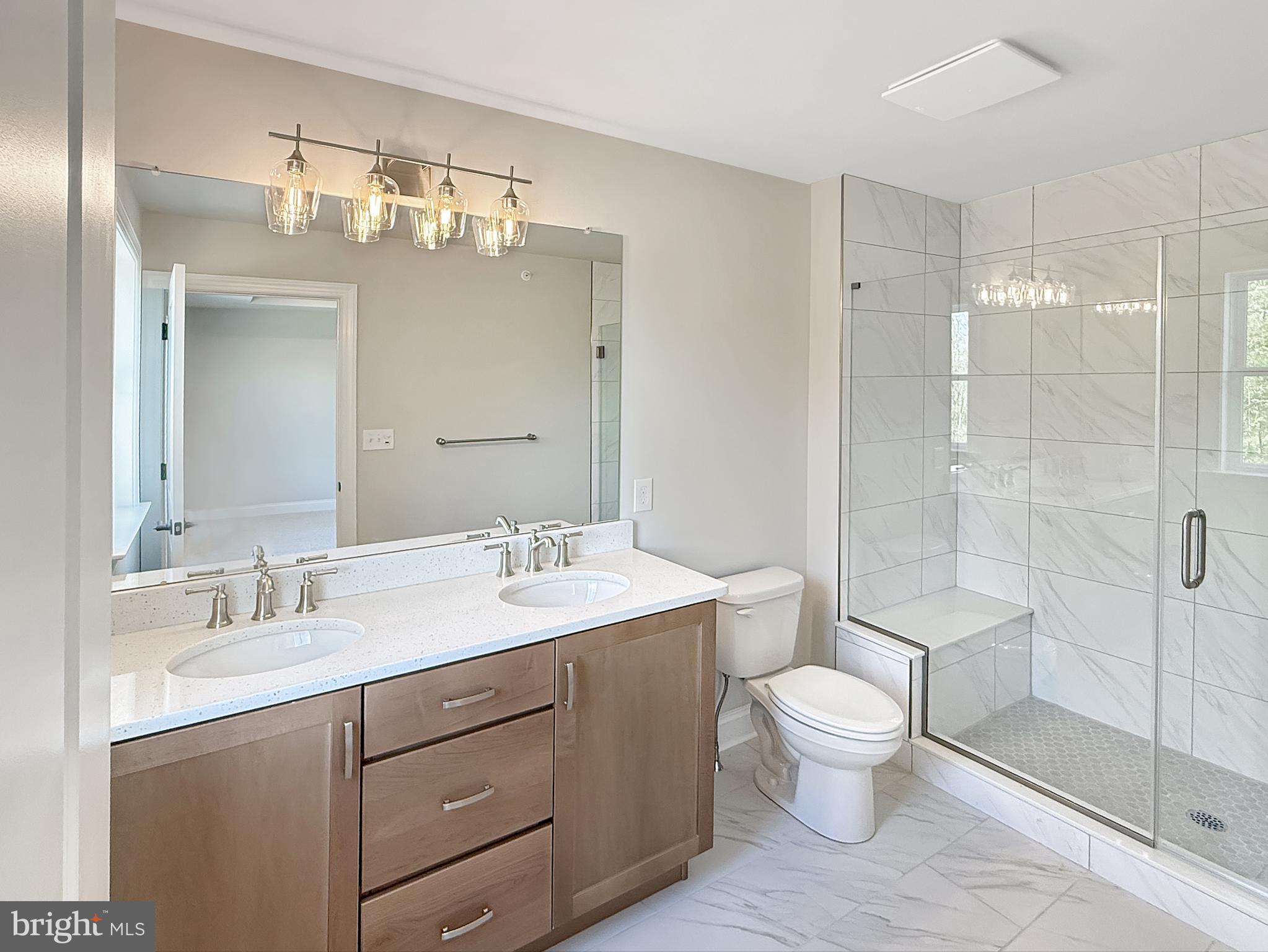 14 Schadle Road Perkasie, PA 18944 - Photo 32 of 44 a bathroom with a toilet a sink a mirror a shower a vanity and window