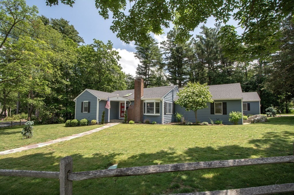 18 Liberty Pole Road Hingham, MA 02043 - Photo 1 of 37 a front view of a house with a yard and trees