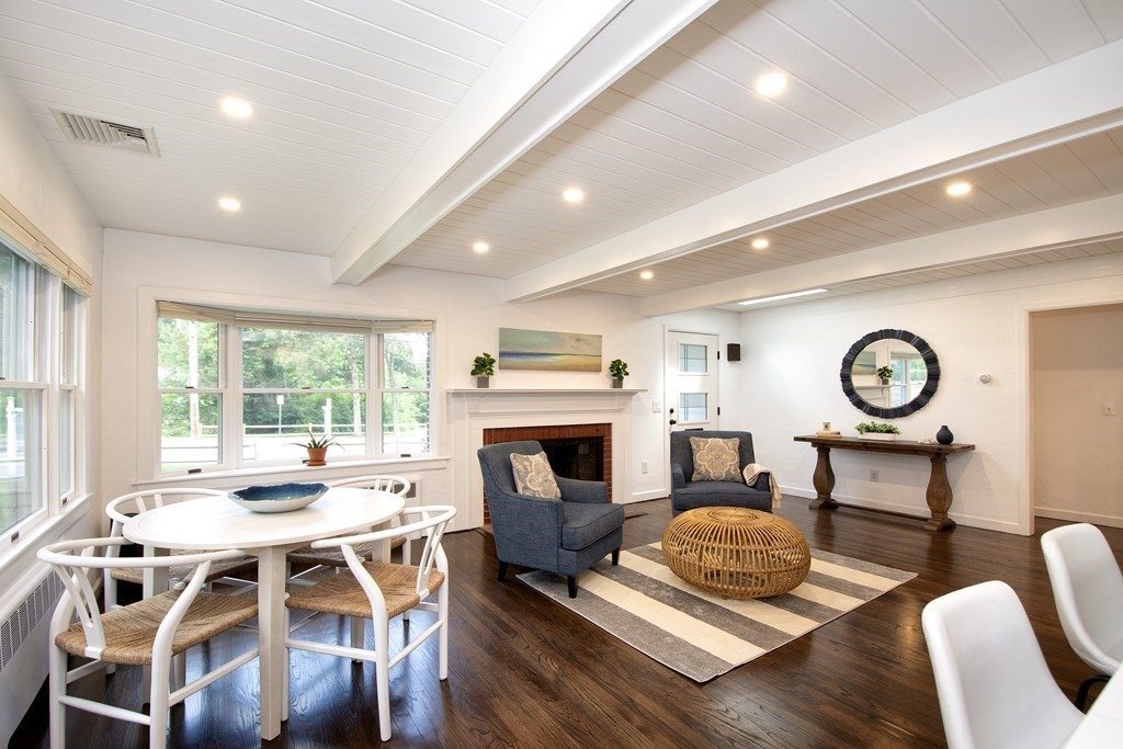 18 Liberty Pole Road Hingham, MA 02043 - Photo 16 of 37 a living room with furniture a fireplace and a large window