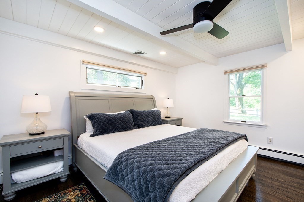 18 Liberty Pole Road Hingham, MA 02043 - Photo 19 of 37 a bedroom with a large bed and a chandelier