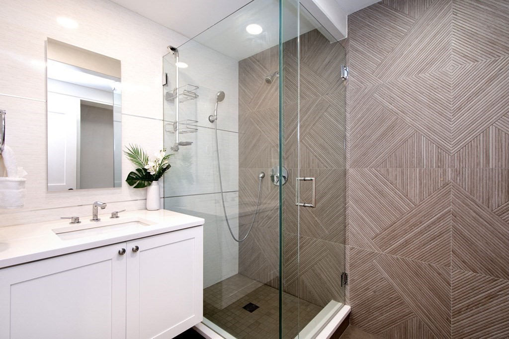 18 Liberty Pole Road Hingham, MA 02043 - Photo 21 of 37 a bathroom with a shower sink vanity and mirror