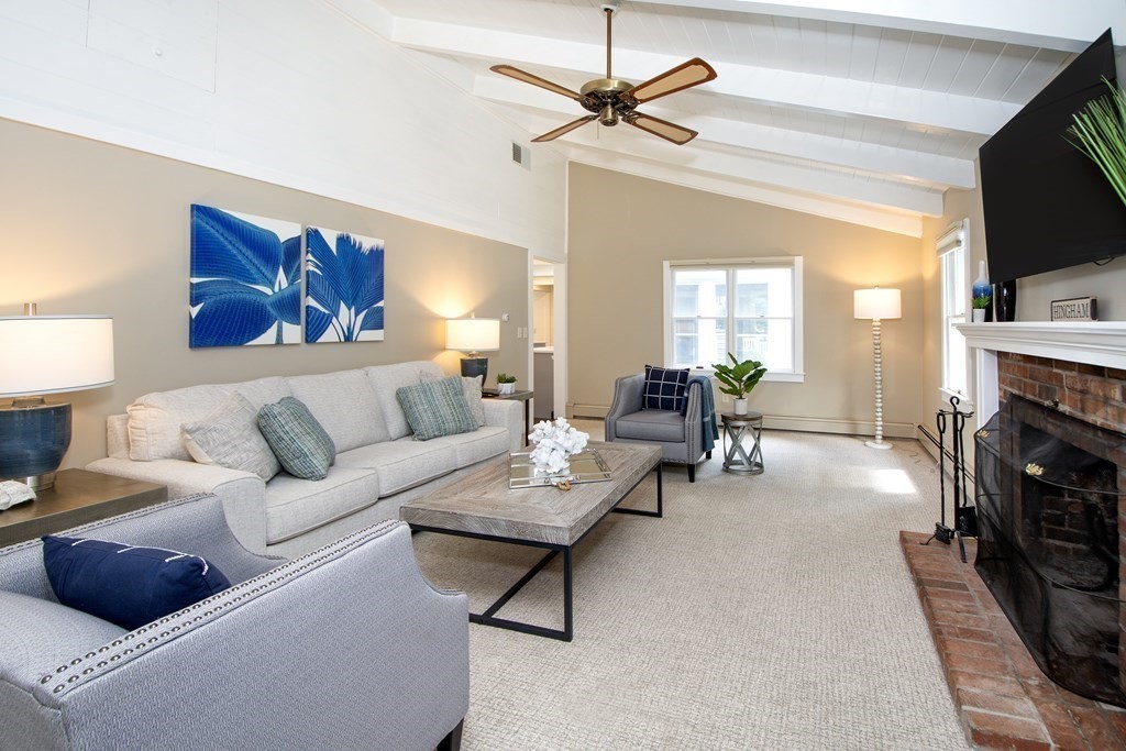 18 Liberty Pole Road Hingham, MA 02043 - Photo 3 of 37 a living room with furniture a fireplace and a flat screen tv