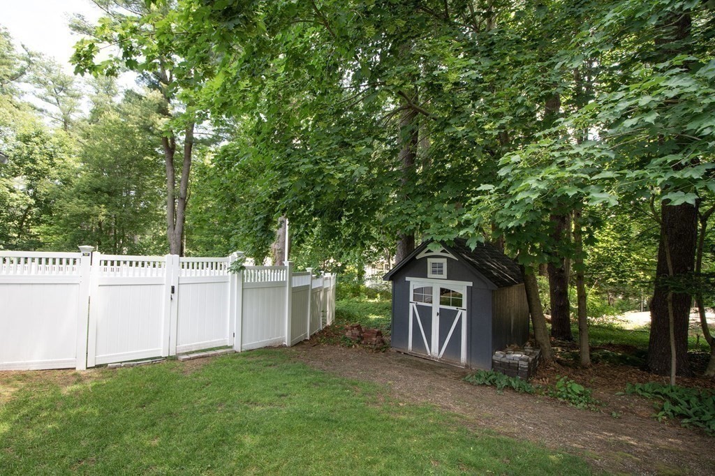 18 Liberty Pole Road Hingham, MA 02043 - Photo 36 of 37 a view of a backyard with plants and large trees