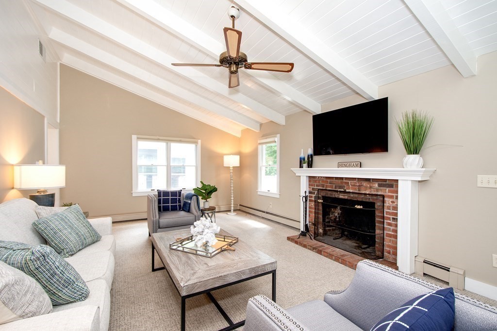 18 Liberty Pole Road Hingham, MA 02043 - Photo 4 of 37 a living room with furniture a fireplace and a flat screen tv