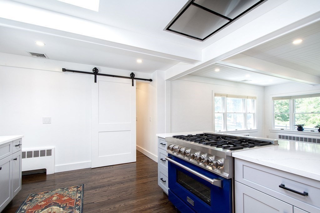 18 Liberty Pole Road Hingham, MA 02043 - Photo 10 of 37 a kitchen with granite countertop a stove and a wooden floor