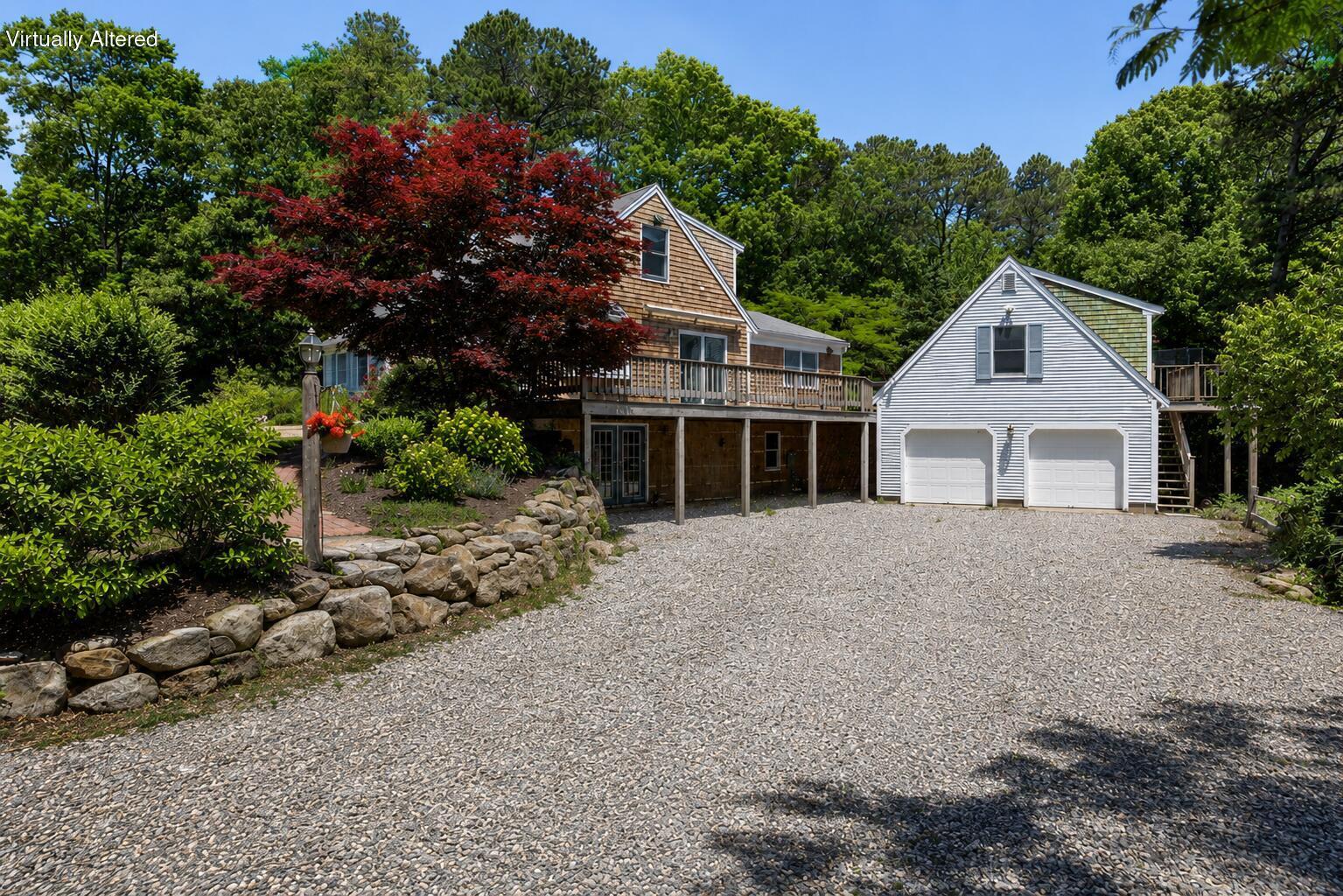 67-69 Bakers Pond Road Orleans, MA 02653 - Photo 2 of 40 a front view of a house with a garden