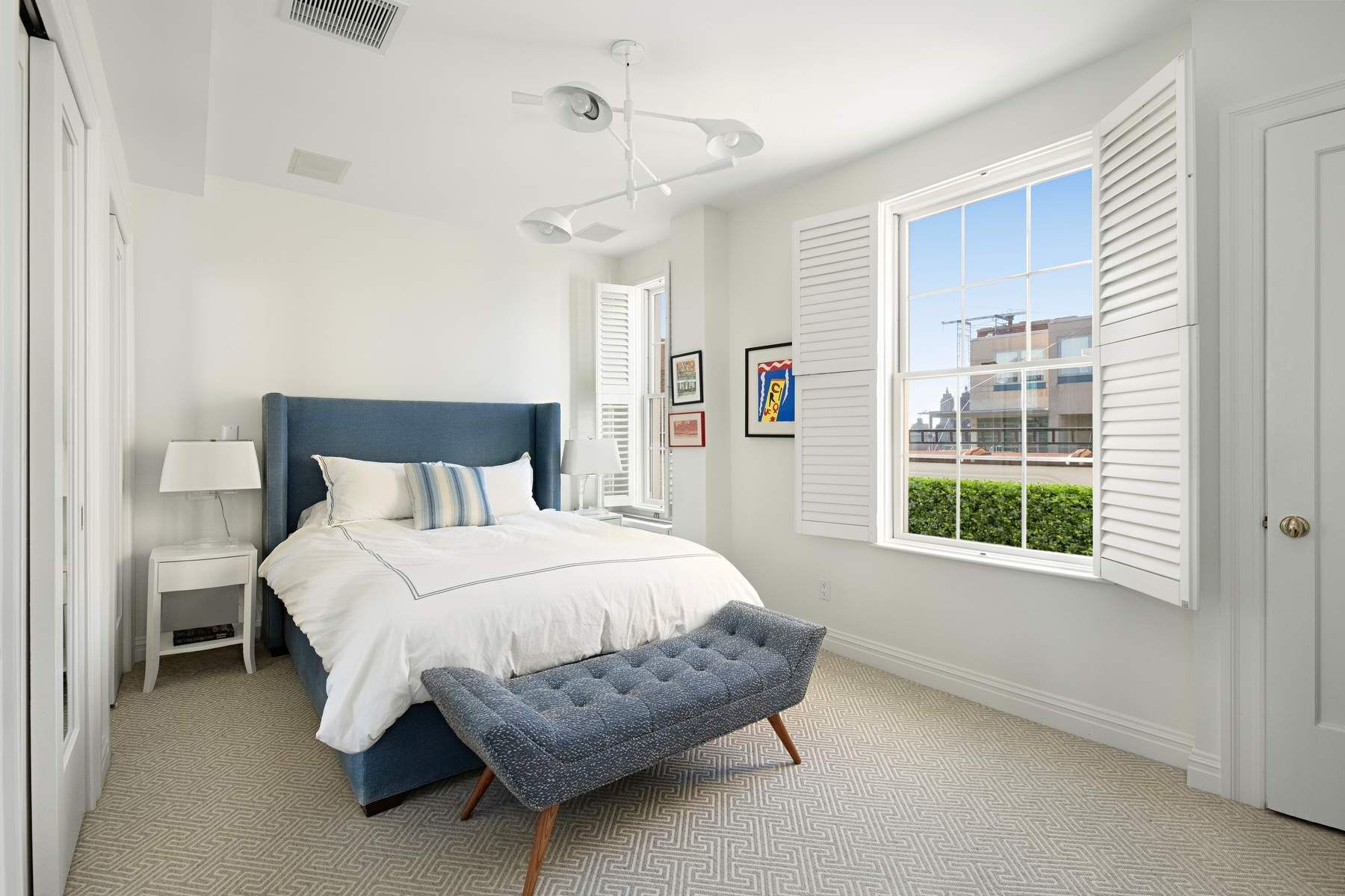 9 East 96th Street, Unit PH Manhattan, NY 10128 - Photo 10 of 18 a bedroom with a bed mirror and a window