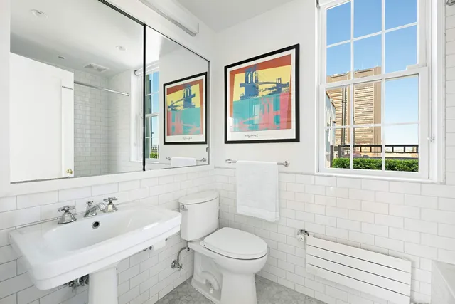 a bedroom with furniture and a large window