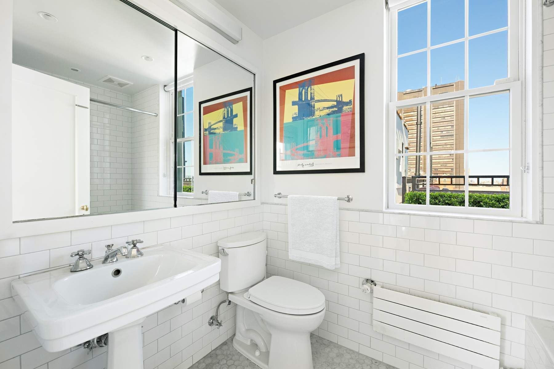 9 East 96th Street, Unit PH Manhattan, NY 10128 - Photo 13 of 18 a bathroom with a toilet sink and mirror