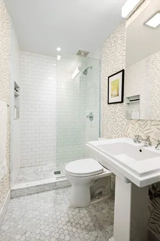 a bedroom with furniture and a large window