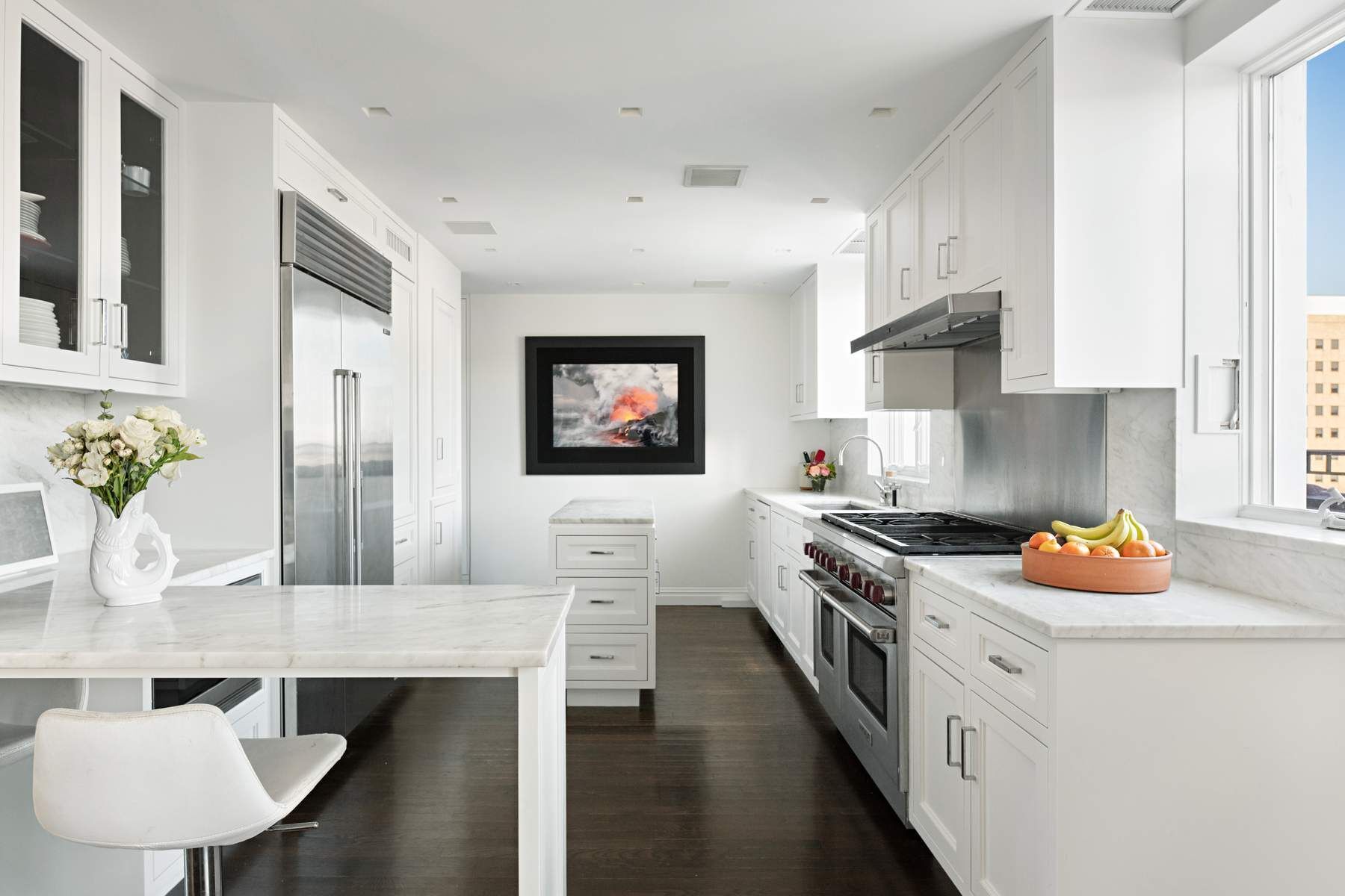 9 East 96th Street, Unit PH Manhattan, NY 10128 - Photo 7 of 18 a kitchen with stainless steel appliances a stove a sink and a refrigerator
