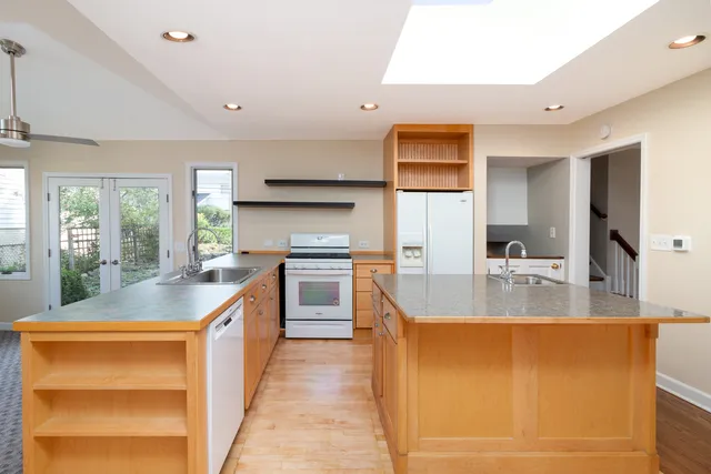 a kitchen with stainless steel appliances granite countertop a sink and a stove