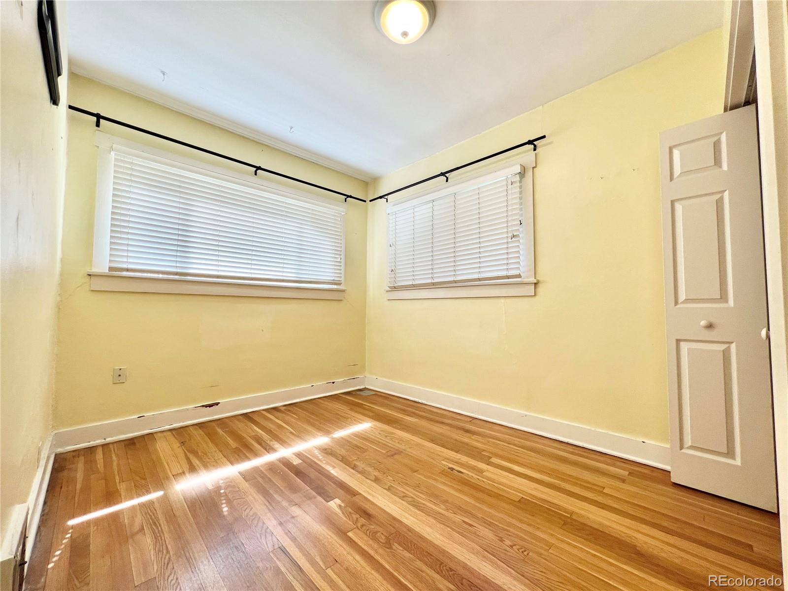 1146 Jackson Street Denver, CO 80206 - Photo 5 of 11 a view of a room with wooden floor and a window