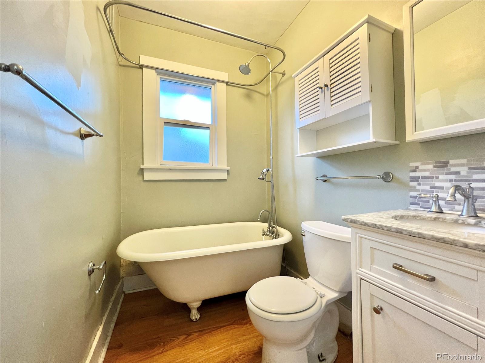 1146 Jackson Street Denver, CO 80206 - Photo 8 of 11 a bathroom with a sink toilet and shower