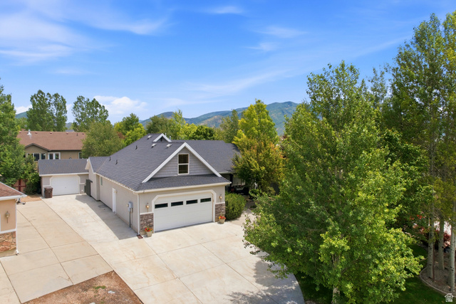 5196 Rodeo Circle Oakley, UT 84055 - Photo 7 of 57 Contemporary-style residence featuring a dark shingled roof, light stucco siding, and stone accents