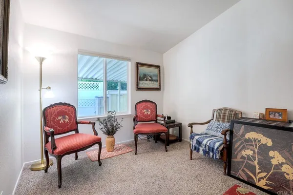 a living room with furniture a window and a lamp