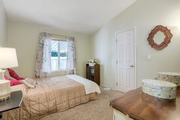 a bedroom with a bed and chandelier