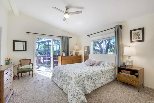a bedroom with a bed couch and a large window