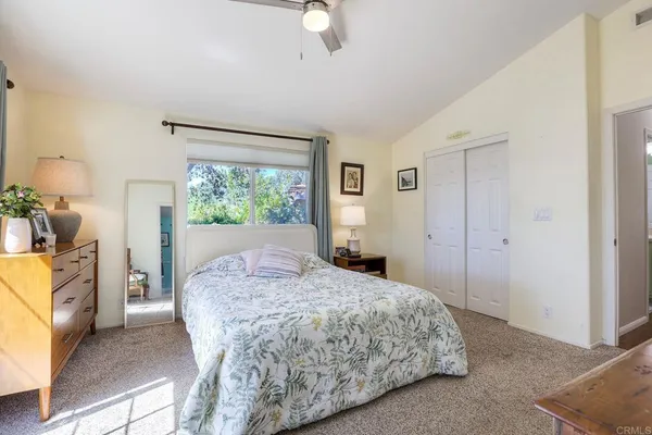 a bedroom with a bed and a fireplace